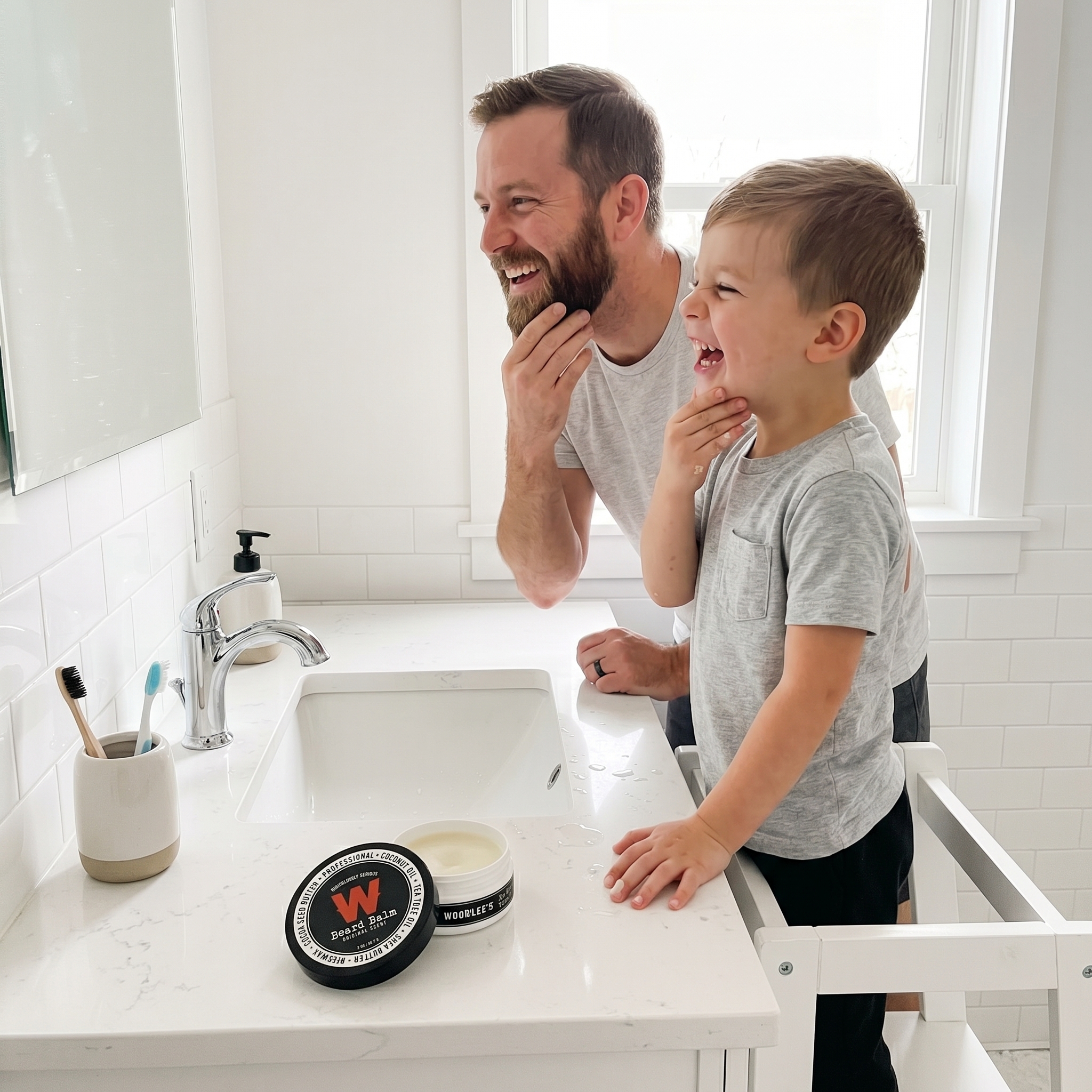 Dad and son laughing during a morning routine with Woodlee's Beard Balm on the counter